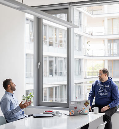 Two employees talking to each other in an office