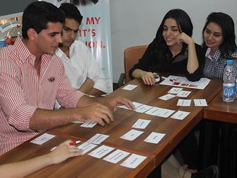 students connecting cards for creating a realistic company storyboard